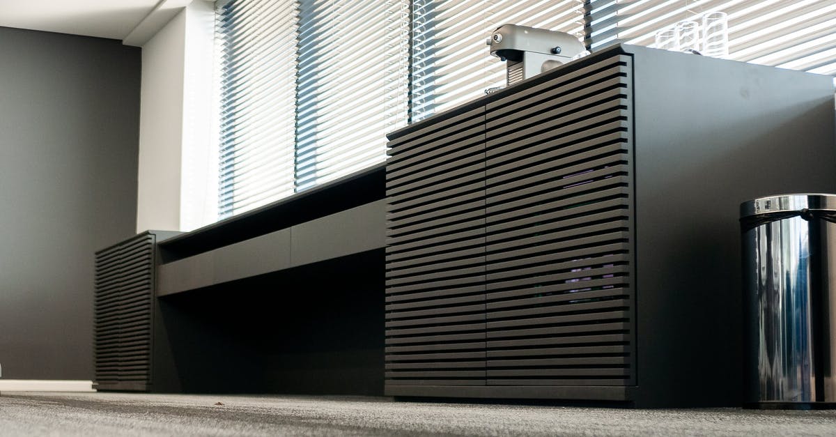 Where can I find the special officers - Table with coffee machine near trash can in modern workspace Where can I find the special officers - Table with coffee machine near trash can in modern workspace