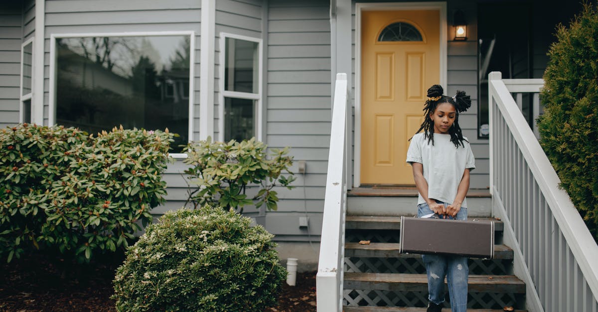 Where did my clan go? - Woman in White Long Sleeve Shirt Sitting on Brown Wooden Bench