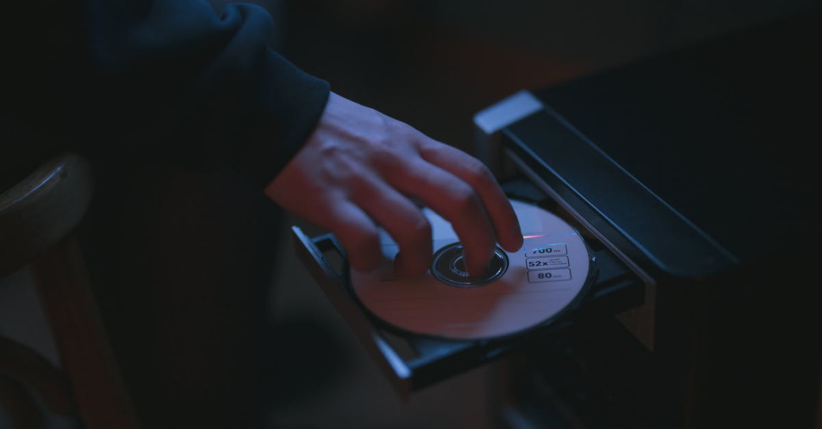 Where do I find the disk needed for the computer? - Person Putting a CD in a Computer