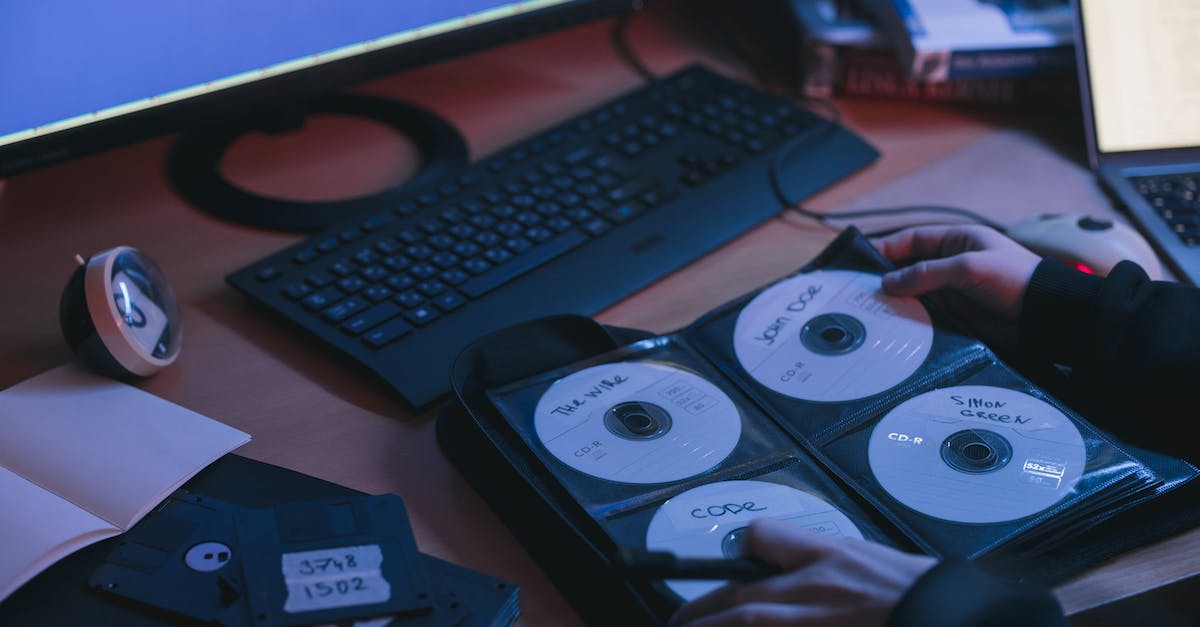 Where do I find the disk needed for the computer? - Person Holding CDs