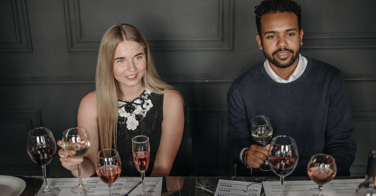 Where is Rico sitting in the menu screen? - Man and Woman Holding Wine Glasses