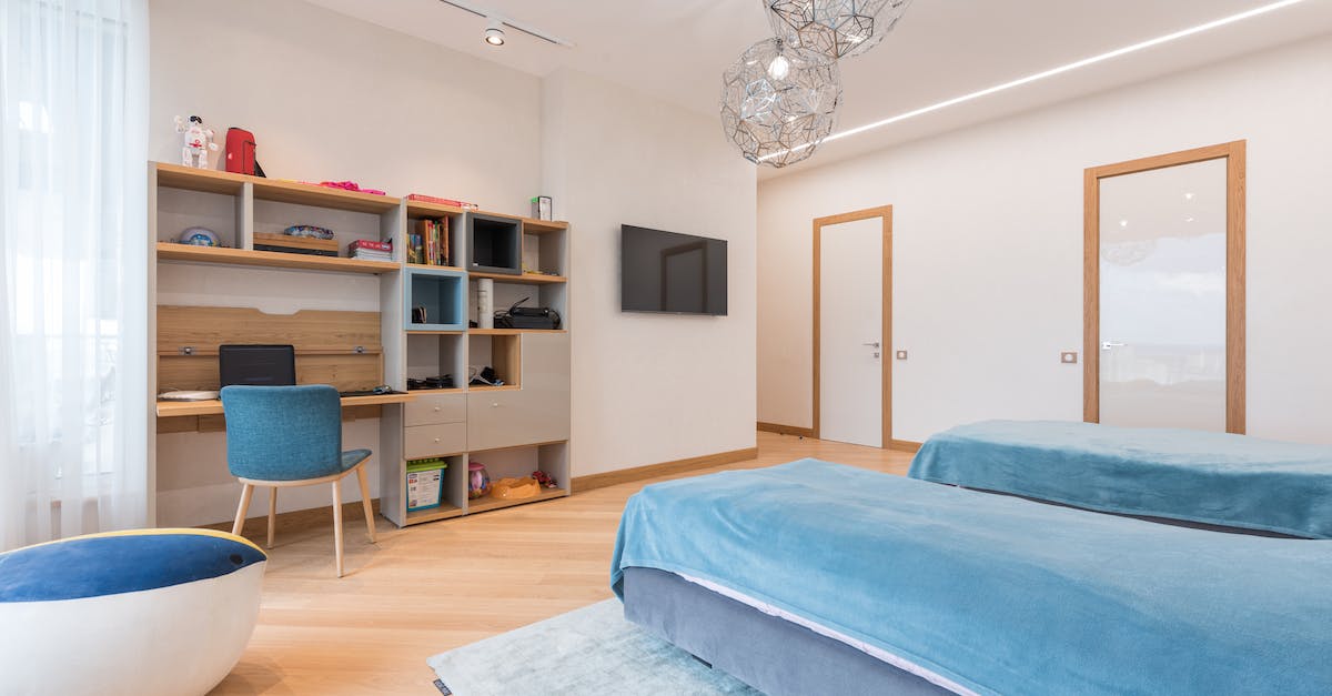 Where is the bed you rent in vault 21? - Interior of modern bedroom with cozy beds and chair placed near wooden desk and bookshelf in contemporary apartment Where is the bed you rent in vault 21? - Interior of modern bedroom with cozy beds and chair placed near wooden desk and bookshelf in contemporary apartment