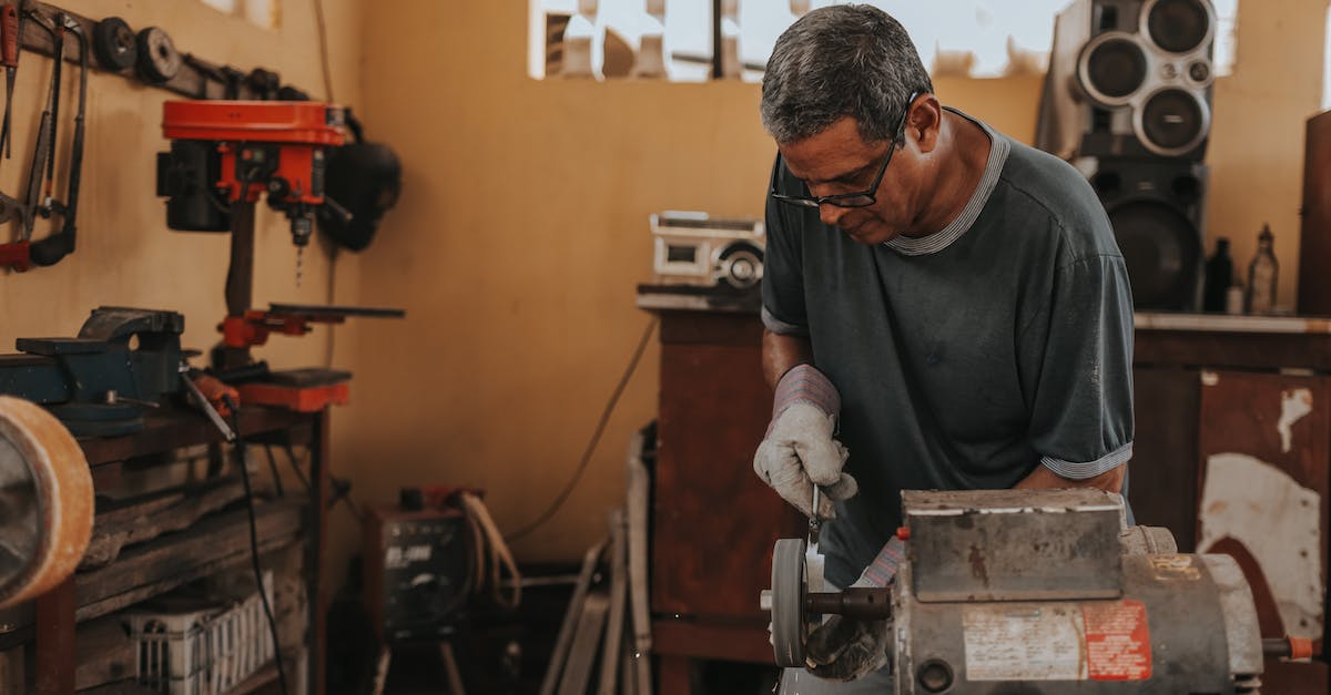 Where is the blacksmith? - Man Using Bench Grinder Where is the blacksmith? - Man Using Bench Grinder