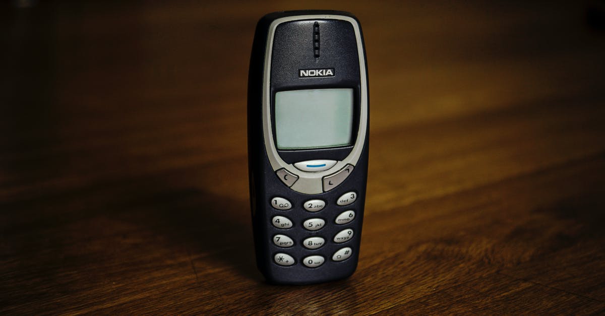 Where is the cell "old cell key" unlocks? - Retro cellphone with buttons placed on table