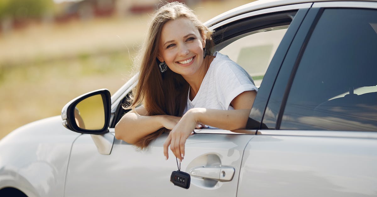 Where is the G key in VIM Adventures? - Happy woman with car key in modern automobile during car trip