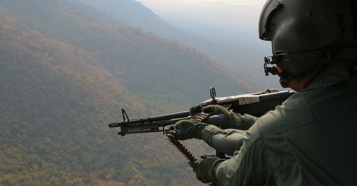 Where is the gunner glyphmaster? - Aerial Photography of Person Holding Machine Gun during Daytime Where is the gunner glyphmaster? - Aerial Photography of Person Holding Machine Gun during Daytime