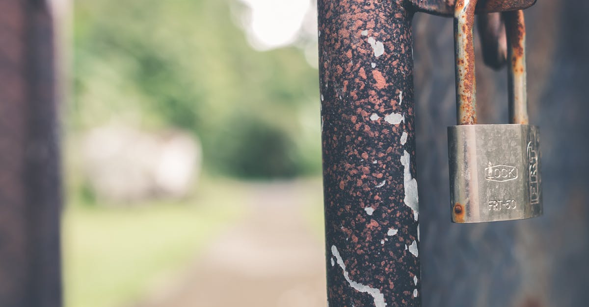 Where is the key to the guarded door? - Rusted Grey Padlock in Selective-focus Photography