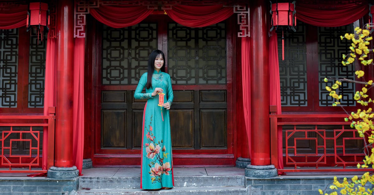 Where is the next mission after Shrine of Oryx? - Woman in Red and Green Floral Dress Standing Near Red Wooden Door