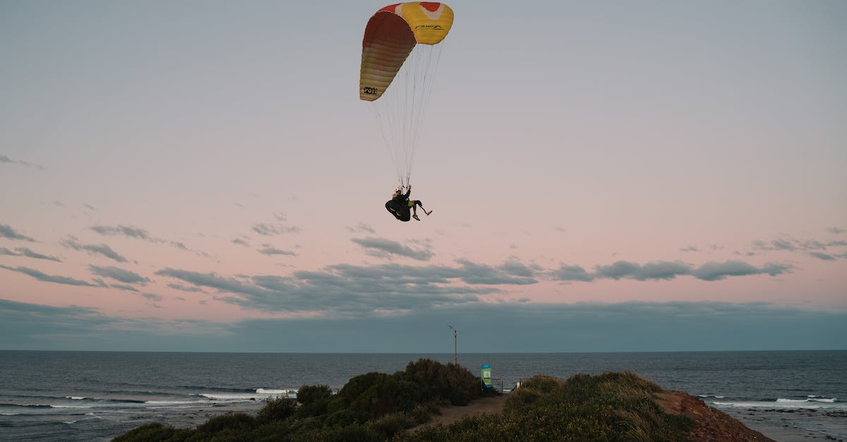 Where is the parachute? - Person in Yellow Parachute over the Sea