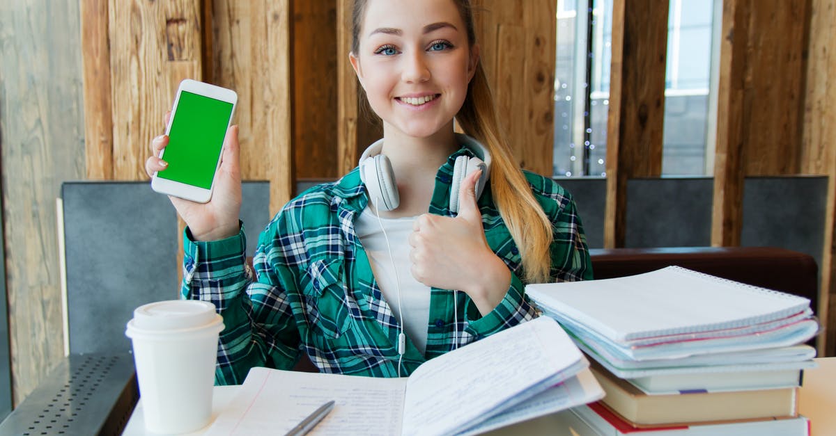 Where is the shader packs folder on Mac? - Smiling Woman Holding White Android Smartphone While Sitting Front of Table