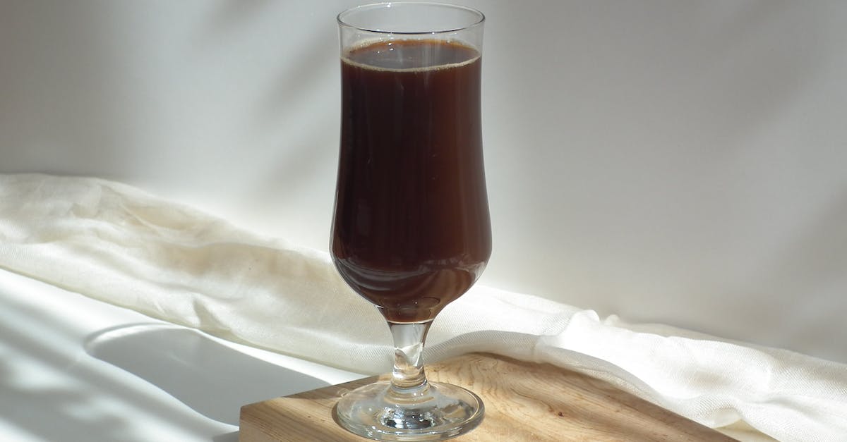 Where is the shadow trinket? - Clear Wine Glass on Brown Wooden Table Where is the shadow trinket? - Clear Wine Glass on Brown Wooden Table