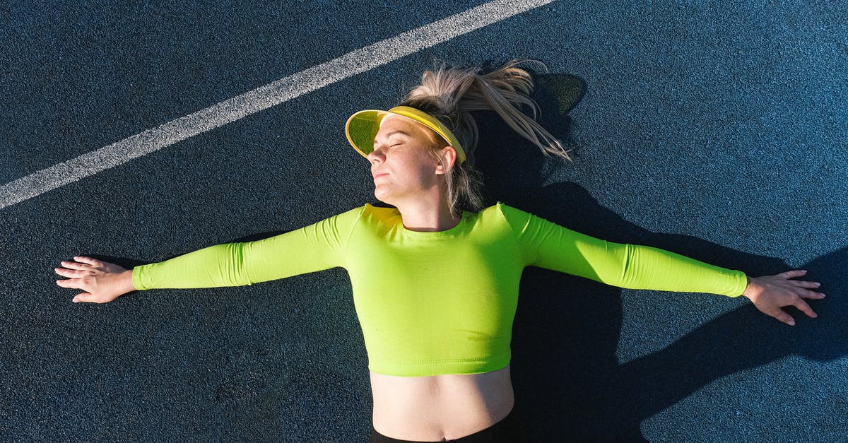 Where is the sun visor? - Relaxed woman lying with outstretched arms Where is the sun visor? - Relaxed woman lying with outstretched arms