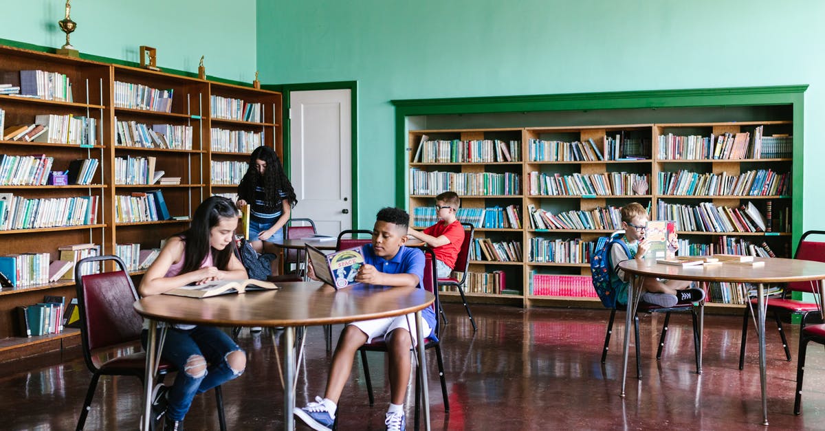Where should I return all of my overdue library books? - People Sitting on Chair in Front of Table