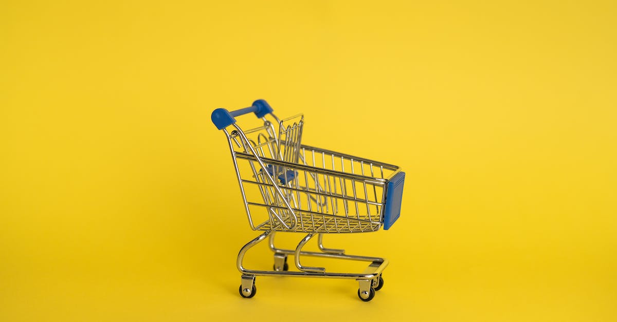Where to buy third-party equipment? - Isolated shining metal shopping trolley without anything located separately on yellow background
