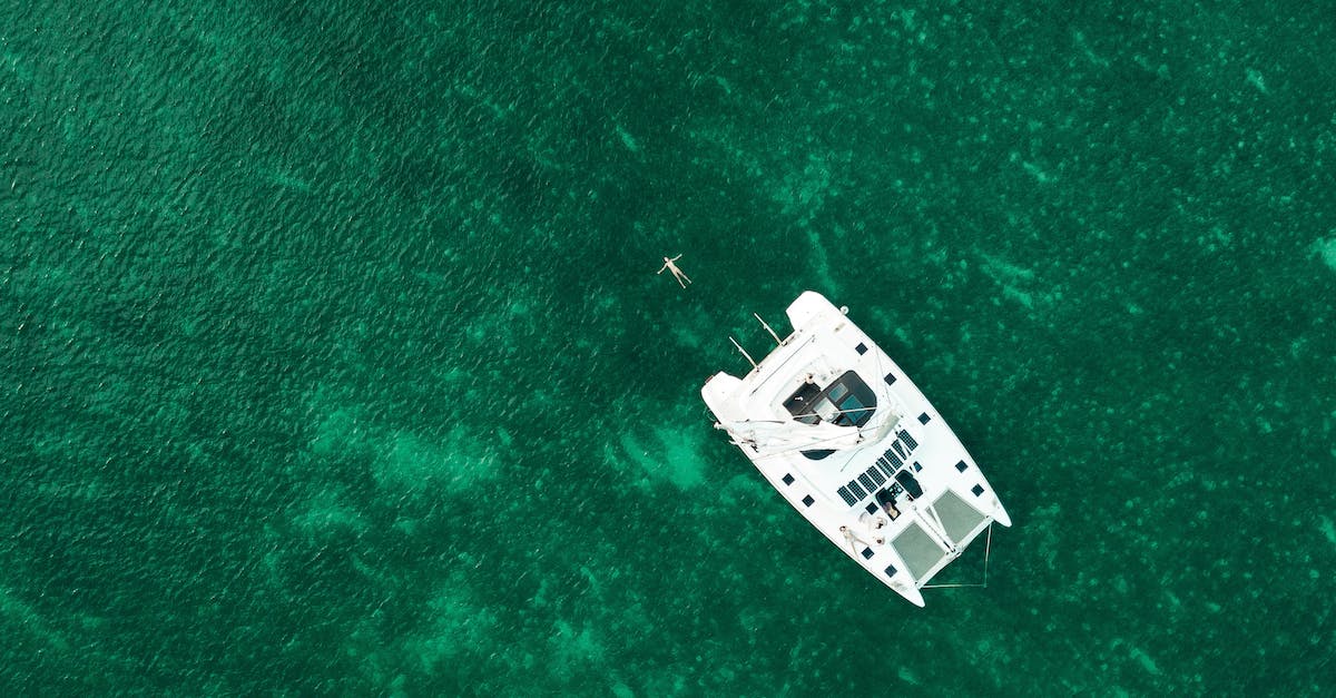 Where to find Emerald Dust in White Orchard? - Modern boat floating in emerald water of clear sea Where to find Emerald Dust in White Orchard? - Modern boat floating in emerald water of clear sea
