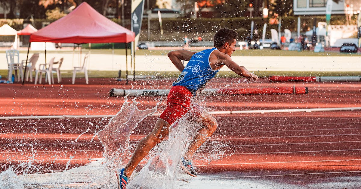 Which action is chosen in case of a tie? - Boy in Blue Tank Top and Red Shorts Playing on Water Fountain Which action is chosen in case of a tie? - Boy in Blue Tank Top and Red Shorts Playing on Water Fountain