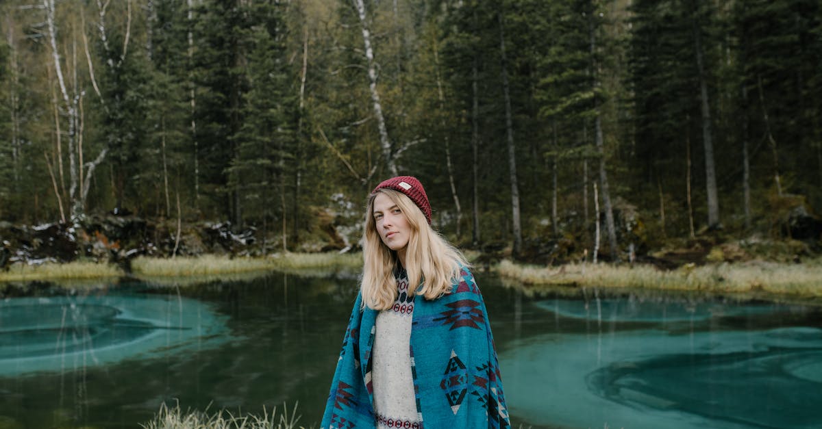 Which adventure game of a female with blonde hair is this? - Calm young female in casual wear and red knitted hat with long hair in forest on lakeside