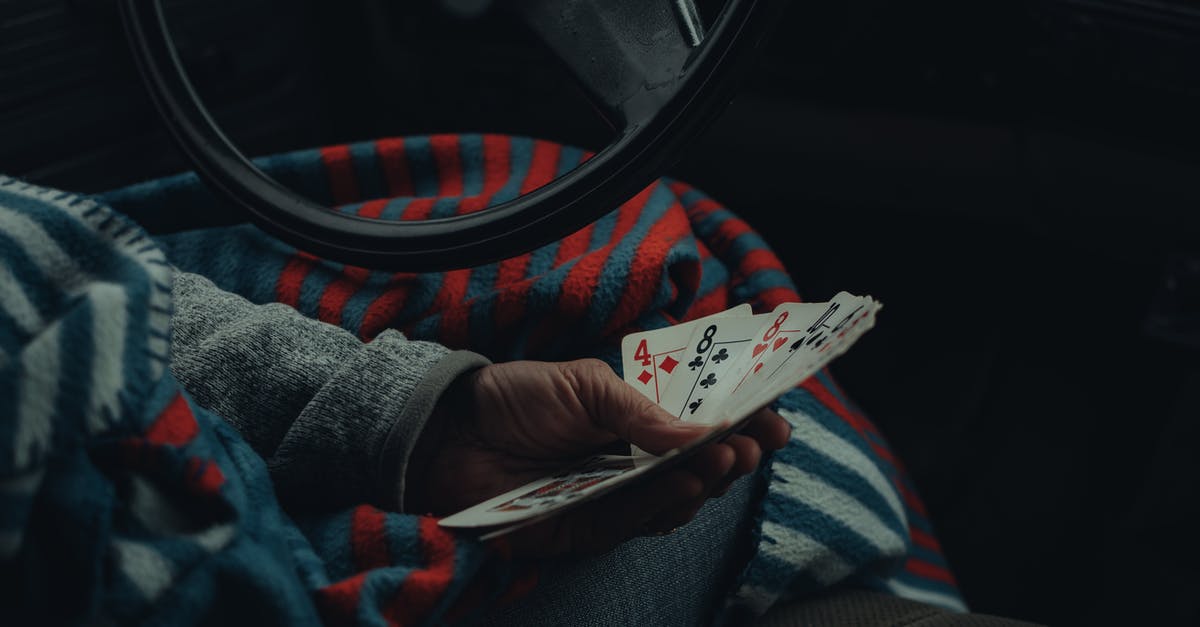 Which cards are legal in MTG Arena's pauper format? - Person Sitting on Driver's Seat While Holding Cards 