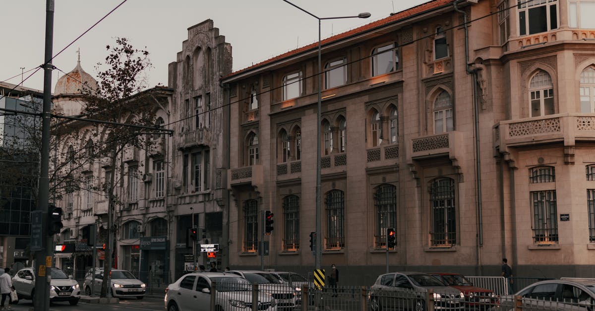 Which cars can best land straight? - Cars Parked in Front of Brown Building