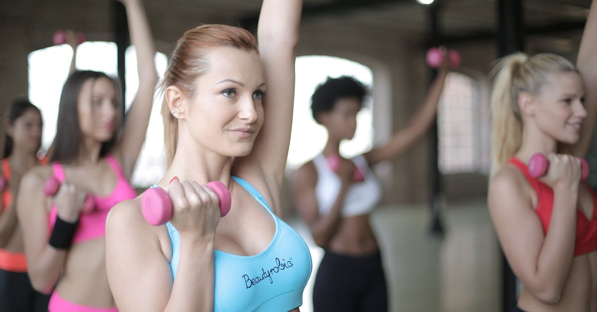 Which characters are in which weight groups? - Young woman doing exercises with dumbbells in fitness center