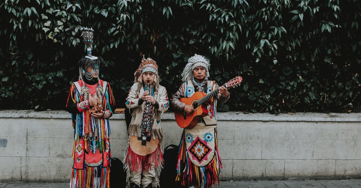 Which clothes are you punished for in the cities of Skyrim? [duplicate] - Three Men in Traditional Native American Clothes Playing Guitar on Side of Road