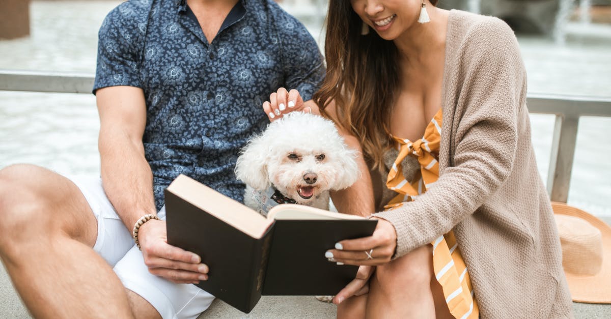 Which companion for a stealth character? - White Dog Sitting Between a Man and a Woman Reading Book Which companion for a stealth character? - White Dog Sitting Between a Man and a Woman Reading Book