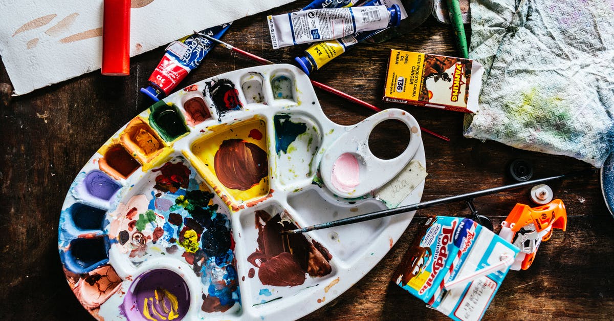 Which curios can have an item used on them for a greater effect? - Top view of various art supplies including paintbrushes with colorful tubes of paint and palette placed on wooden table
