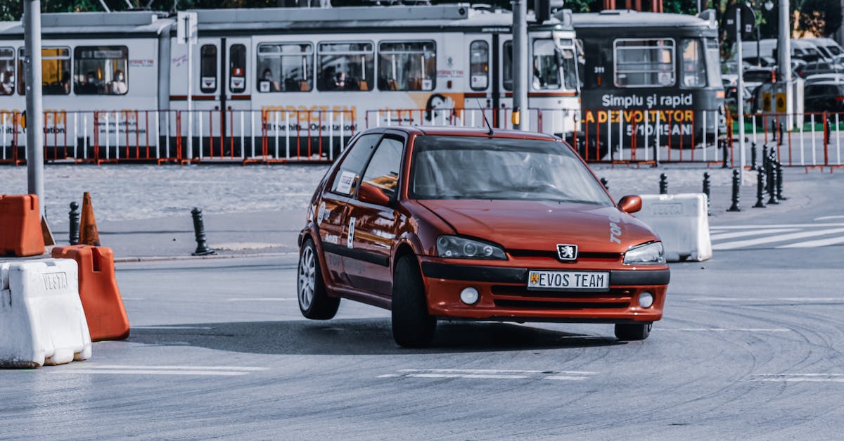 Which direction do Coconut Wheels turn if they are destroyed? - Gleaming red automobile driving on street with tram on sunny day in summer