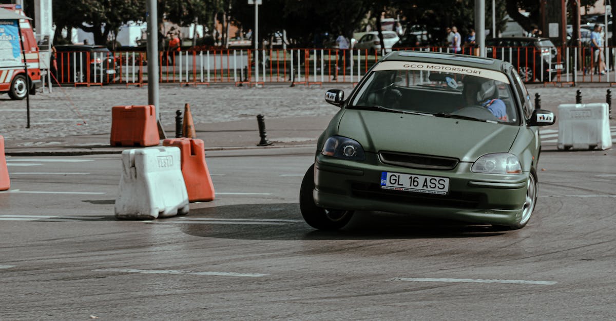 Which direction do Coconut Wheels turn if they are destroyed? - Old green car driving fast while turning on asphalt route of urban rally races