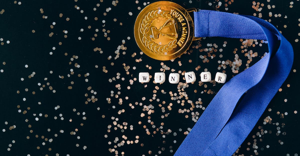 Which factors contribute to your Champion Grade? [closed] - Close-Up Shot of a Gold Medal on a Black Surface