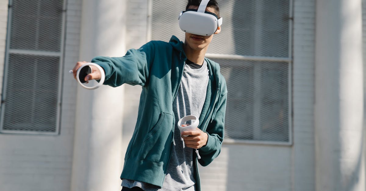 Which Fallout game was it first stated that vaults were designed to conduct experiments? - Man in virtual reality goggles with controllers playing video game against urban building in sunlight