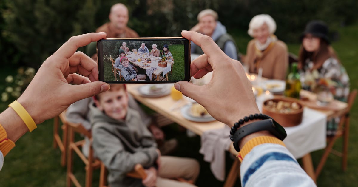 Which game does this screen capture depicting a wilderness scene belong to? - Unrecognizable person taking photo of family dinner on smartphone Which game does this screen capture depicting a wilderness scene belong to? - Unrecognizable person taking photo of family dinner on smartphone