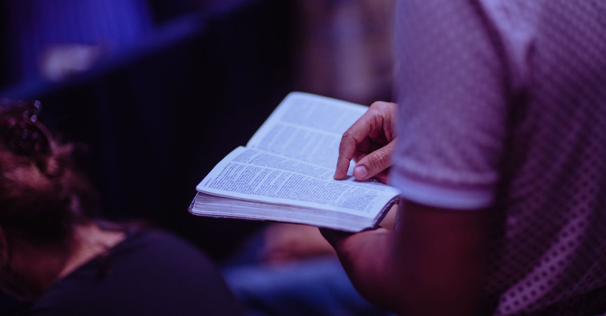 Which god do I serve? - Selective Focus Photo of Person Holding Book Which god do I serve? - Selective Focus Photo of Person Holding Book