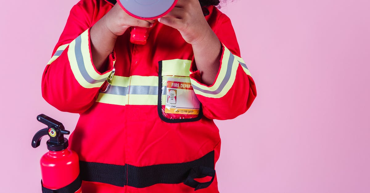 Which hero gets a "Game Won" in the statistics if I switch heroes mid-game? - Crop unrecognizable little ethnic kid wearing fireman costume and fire extinguisher while using loudspeaker toy and standing on pink background