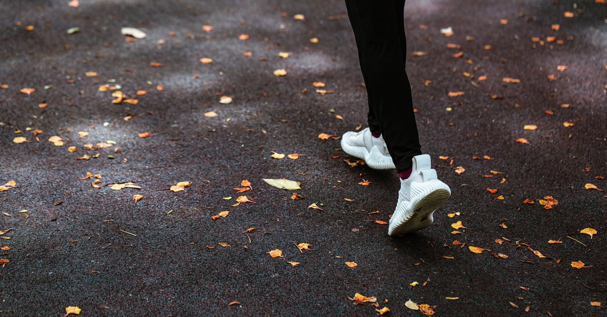Which heroes move the fastest along the ground? - Faceless person running on dark pavement Which heroes move the fastest along the ground? - Faceless person running on dark pavement