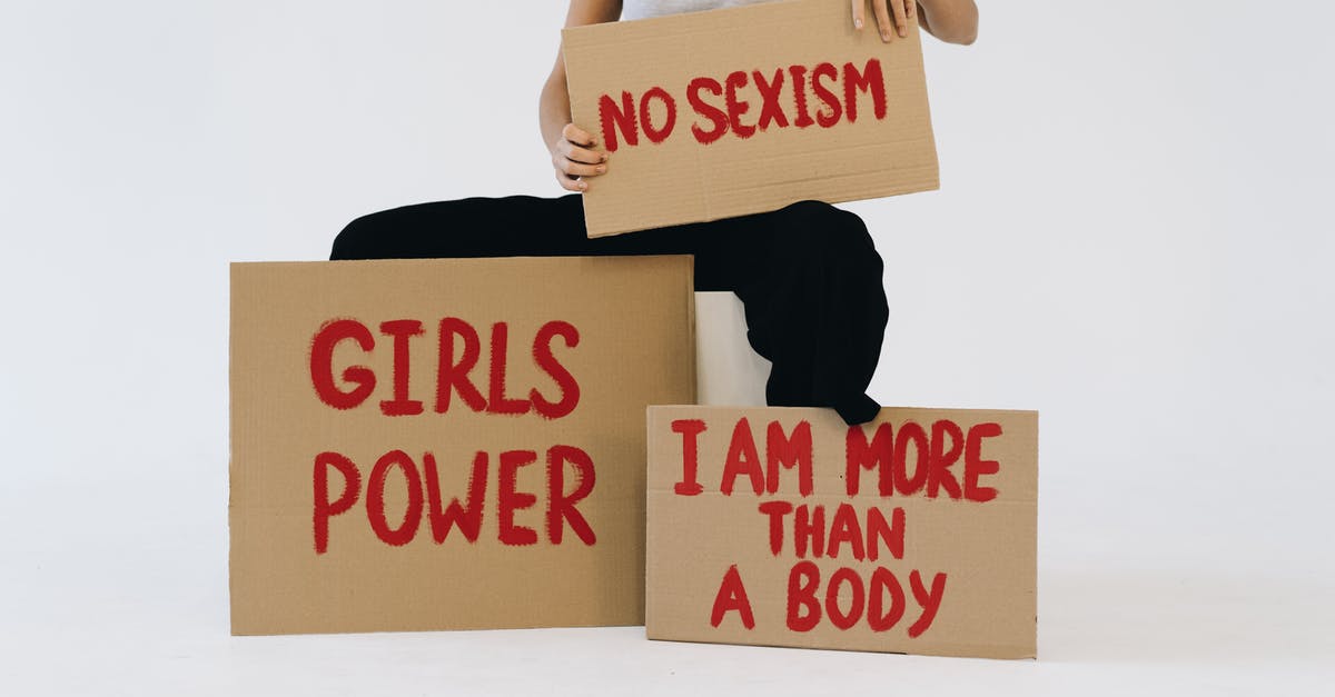 Which HM is more powerful? - A Woman Showing Three Placards Which HM is more powerful? - A Woman Showing Three Placards