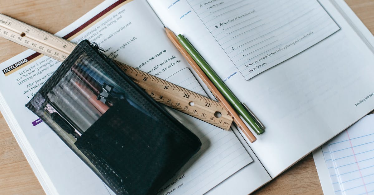 Which items from the Gun Mettle Cosmetic Case can be Unusual? - From above of textbook with exercises and ruler with pens near small case on table Which items from the Gun Mettle Cosmetic Case can be Unusual? - From above of textbook with exercises and ruler with pens near small case on table