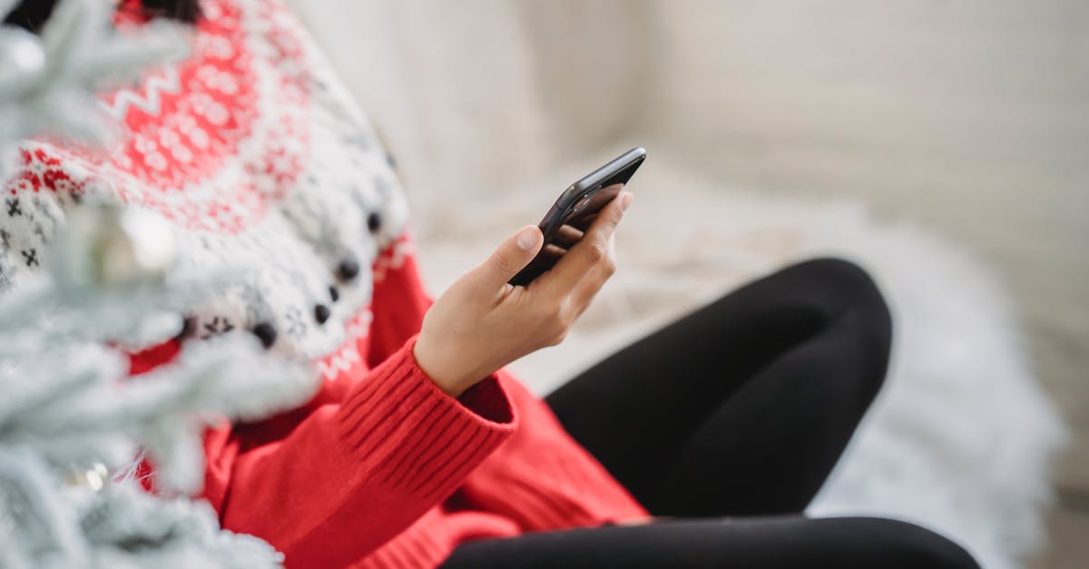 Which items in EVE Online are classified as 'Meta 0' items? - Crop anonymous female in cozy soft sweater browsing modern mobile phone while sitting near white decorated Christmas tree Which items in EVE Online are classified as 'Meta 0' items? - Crop anonymous female in cozy soft sweater browsing modern mobile phone while sitting near white decorated Christmas tree