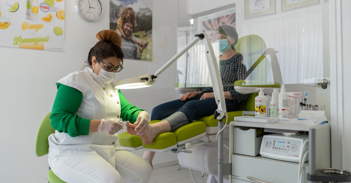 Which jobs have occupational hazards? - Concentrated professional beauty master in protective mask and gloves doing pedicure in modern salon Which jobs have occupational hazards? - Concentrated professional beauty master in protective mask and gloves doing pedicure in modern salon