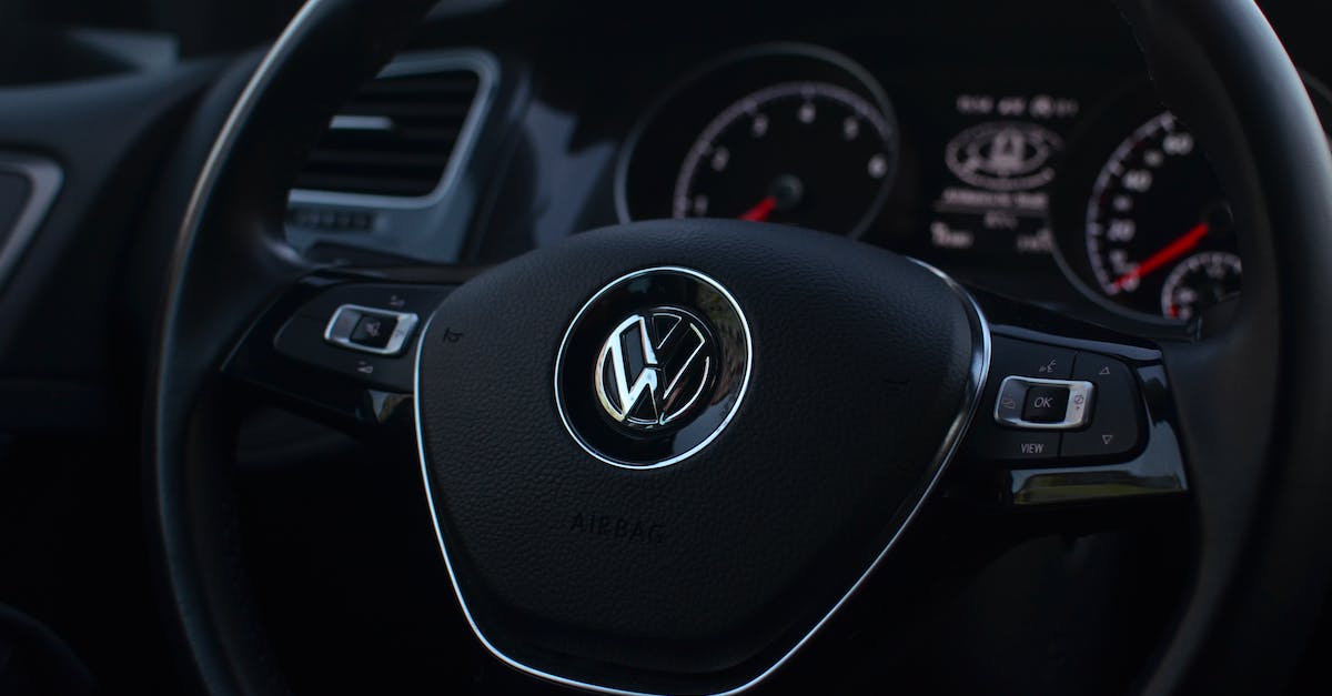 Which parts panel contains control surfaces? - Interior of modern automobile with buttons on steering wheel with panel containing instruments and controls