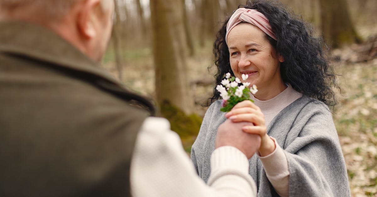 Which placed items give free buffs? - Happy senior couple in love with flowers in forest Which placed items give free buffs? - Happy senior couple in love with flowers in forest