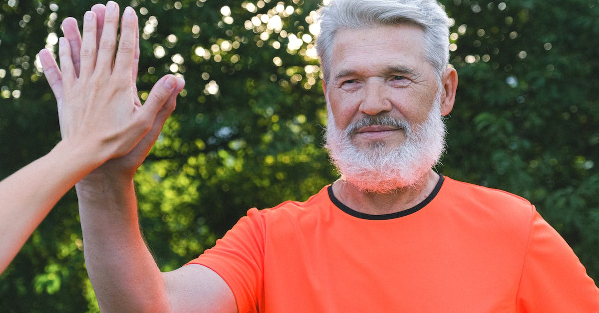 Which placed items give free buffs? - Calm aged man with beard in bright t shirt giving high five to anonymous person in park in sunny day Which placed items give free buffs? - Calm aged man with beard in bright t shirt giving high five to anonymous person in park in sunny day