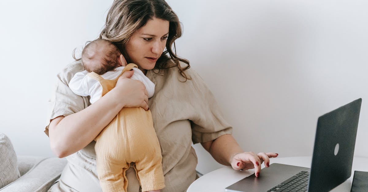 Which Pokémon of the first generation is the most resistant to all types? - Concentrated young female freelancer embracing newborn while sitting at table and working remotely on laptop at home