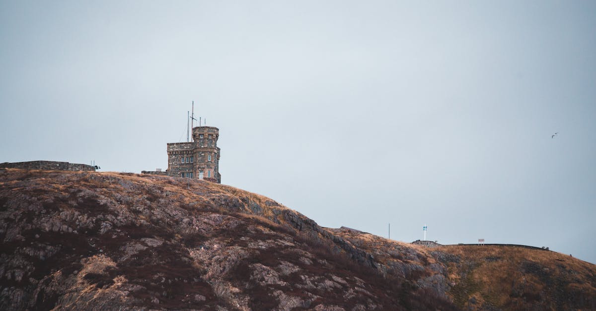 Which provinces are "Canadian"? - Old tower facade on hill under light sky