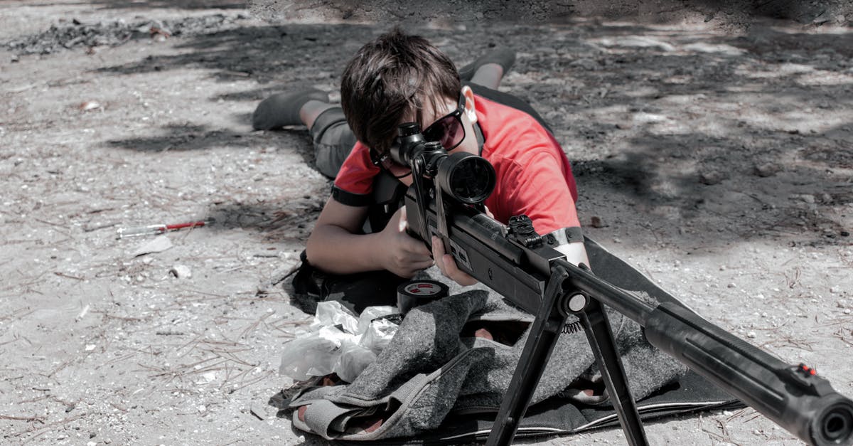 Which sniper scope has the highest zoom and where is it found? - A Man Using a Sniper Rifle 