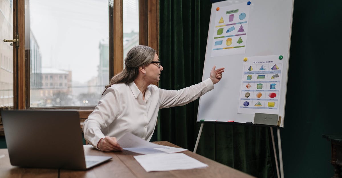 Which sniper scope has the highest zoom and where is it found? - Woman in White Long Sleeve Shirt Sitting by the Table Using Macbook
