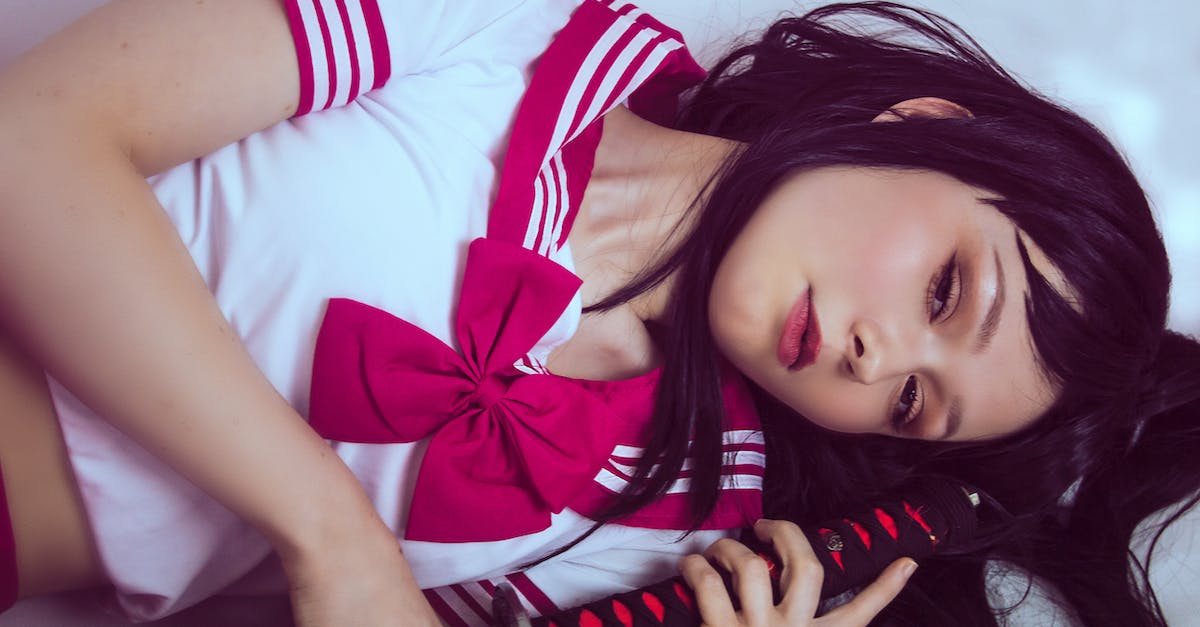 Which sword skin is this? - Woman in White and Red Crop Top With Bow Accent Holding Black and Red Handled Sword While Lying Which sword skin is this? - Woman in White and Red Crop Top With Bow Accent Holding Black and Red Handled Sword While Lying