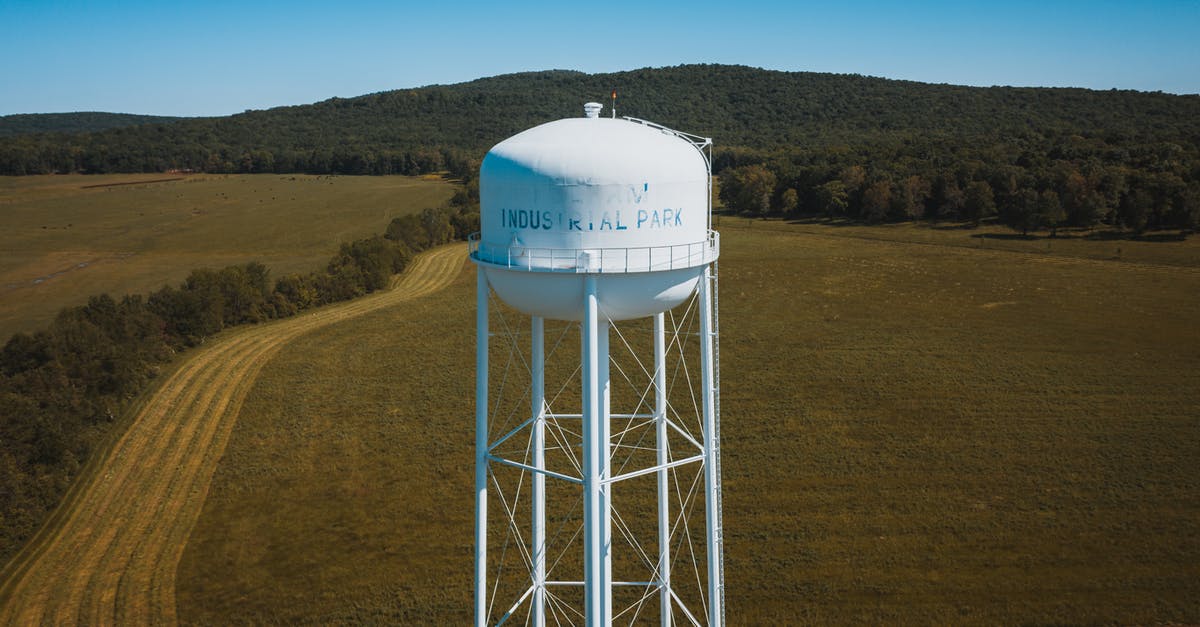 Which tank has the most rebound naturally? - Water tower in green field behind mountain