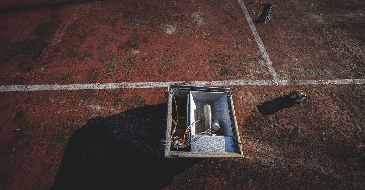 Which types of damage for the end game? - From above of outdoor lamp box placed on rough dirty ground of sports court on sunny day Which types of damage for the end game? - From above of outdoor lamp box placed on rough dirty ground of sports court on sunny day