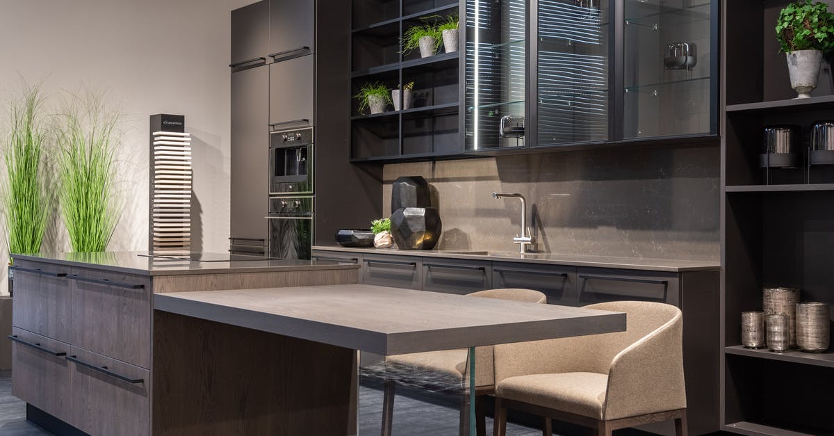 Which units are considered "flat-chested"? - Modern trendy kitchen interior with dark cabinets and counter in spacious contemporary flat Which units are considered "flat-chested"? - Modern trendy kitchen interior with dark cabinets and counter in spacious contemporary flat